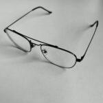 Black metal-framed eyeglasses on white background